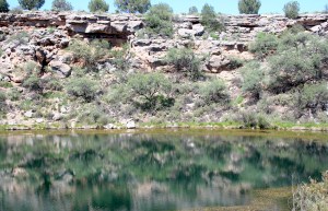 Almost perfectly still, the well reflects the sky and its walls more vibrantly than the exist in real life. 